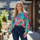 LAGUNA LUXE BLOUSE - JODIFL in vibrant teal and aqua with bold floral patterns, perfect for stylish outfits.