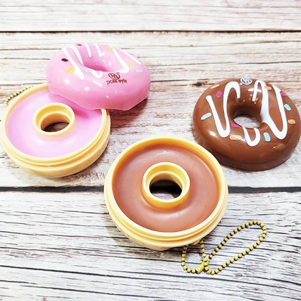 Colorful Donut Worry Lip Balms on a wooden background, attached to key chains for easy use.