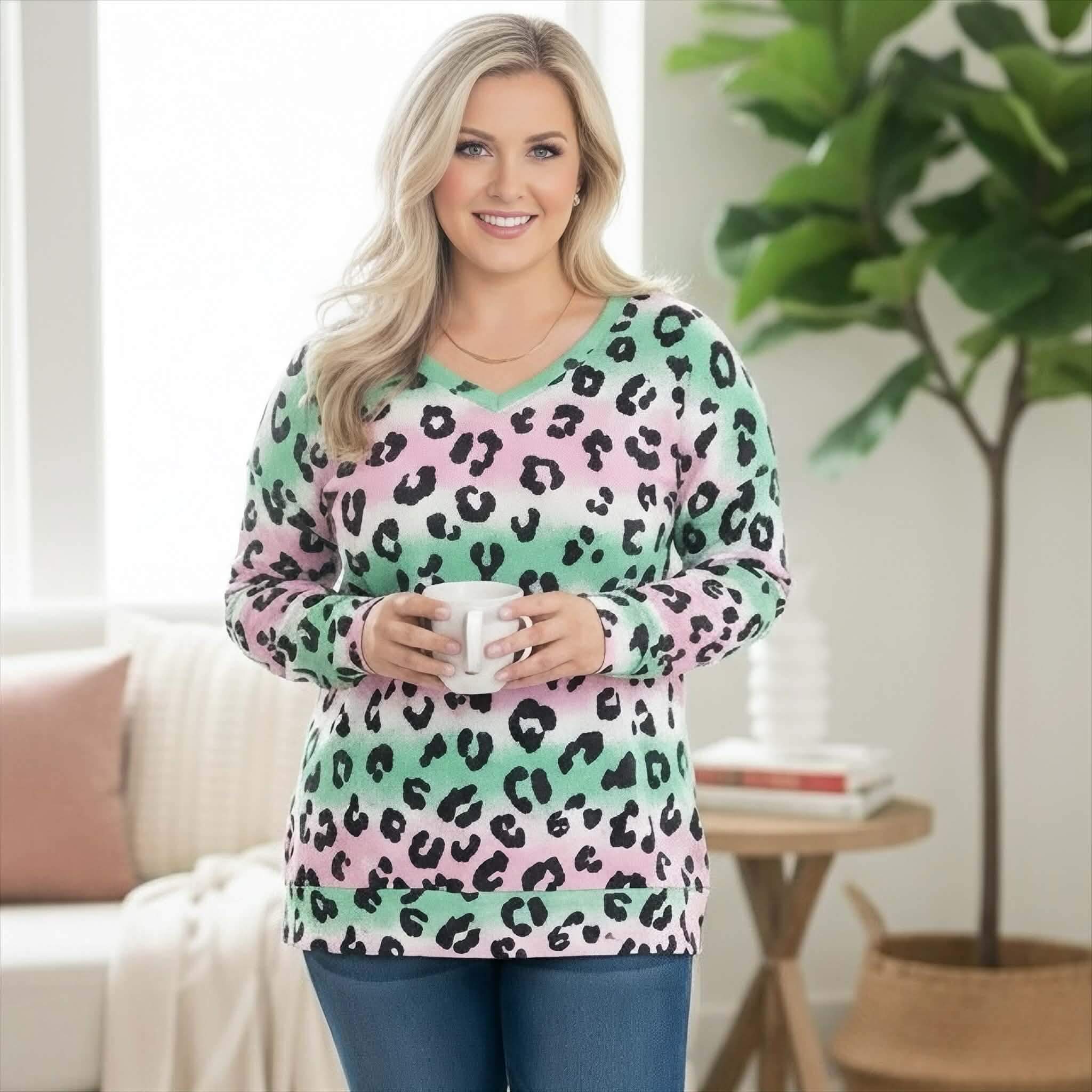 Pretty Prowl Top - Zenana featuring a woman in a playful leopard print top holding a cup.