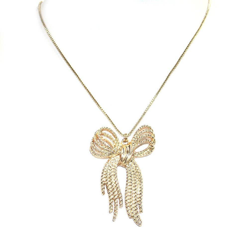Beautiful gold tone bow necklace with intricate pendant, perfect for elegant occasions and everyday wear.