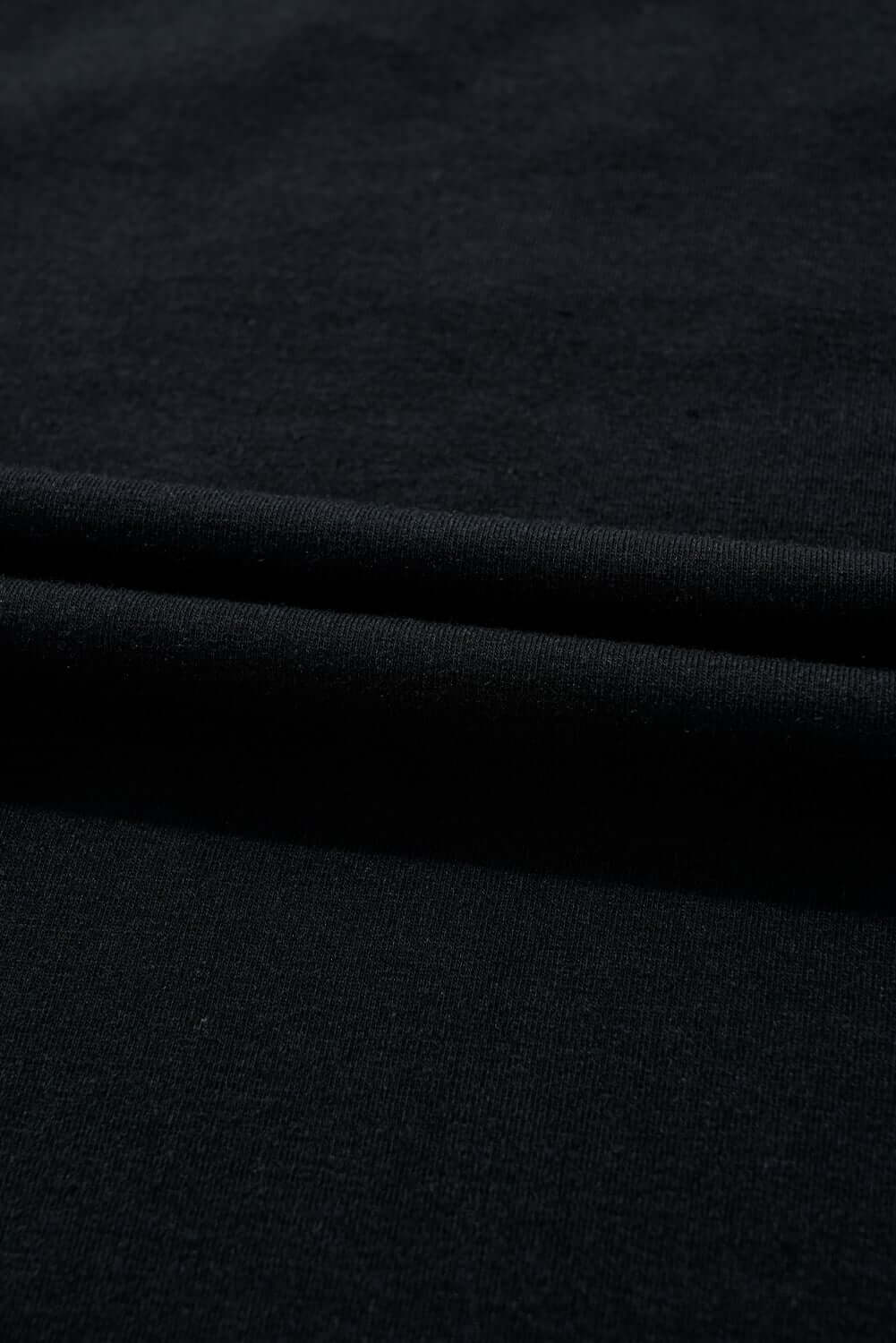 Close-up of soft black cotton blend fabric, perfect for stylish t-shirts like CHRISTMAS GEMS by Vivian-Lu.