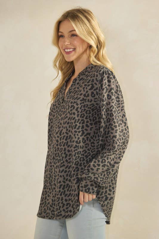 ET7975-14 LONG SLEEVE V NECK ANIMAL URBAN RIB TOP modeled by a woman, showcasing its stylish animal print design.