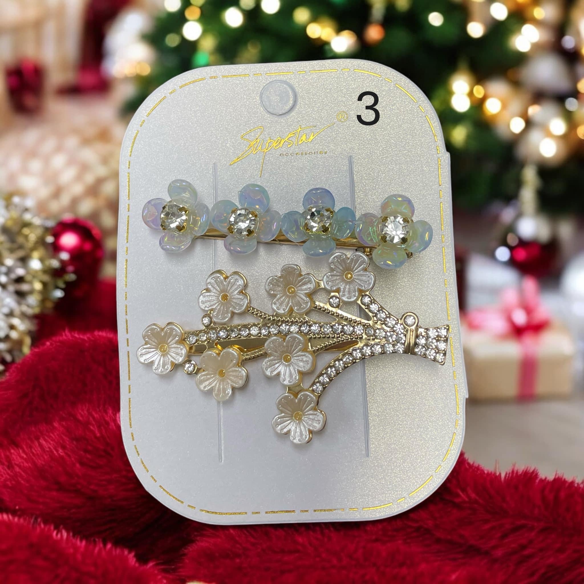 Set of two rhinestone and flower hair clips in elegant packaging, perfect for holiday styling.