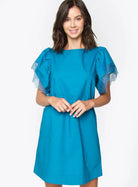 Model wearing the Camilia Dress by SugarLips in vibrant blue with crochet trim sleeves, perfect for stylish outings.
