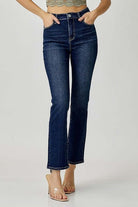Model wearing Risen ADELINE midrise straight jeans in dark wash, showcasing a trendy, versatile style.