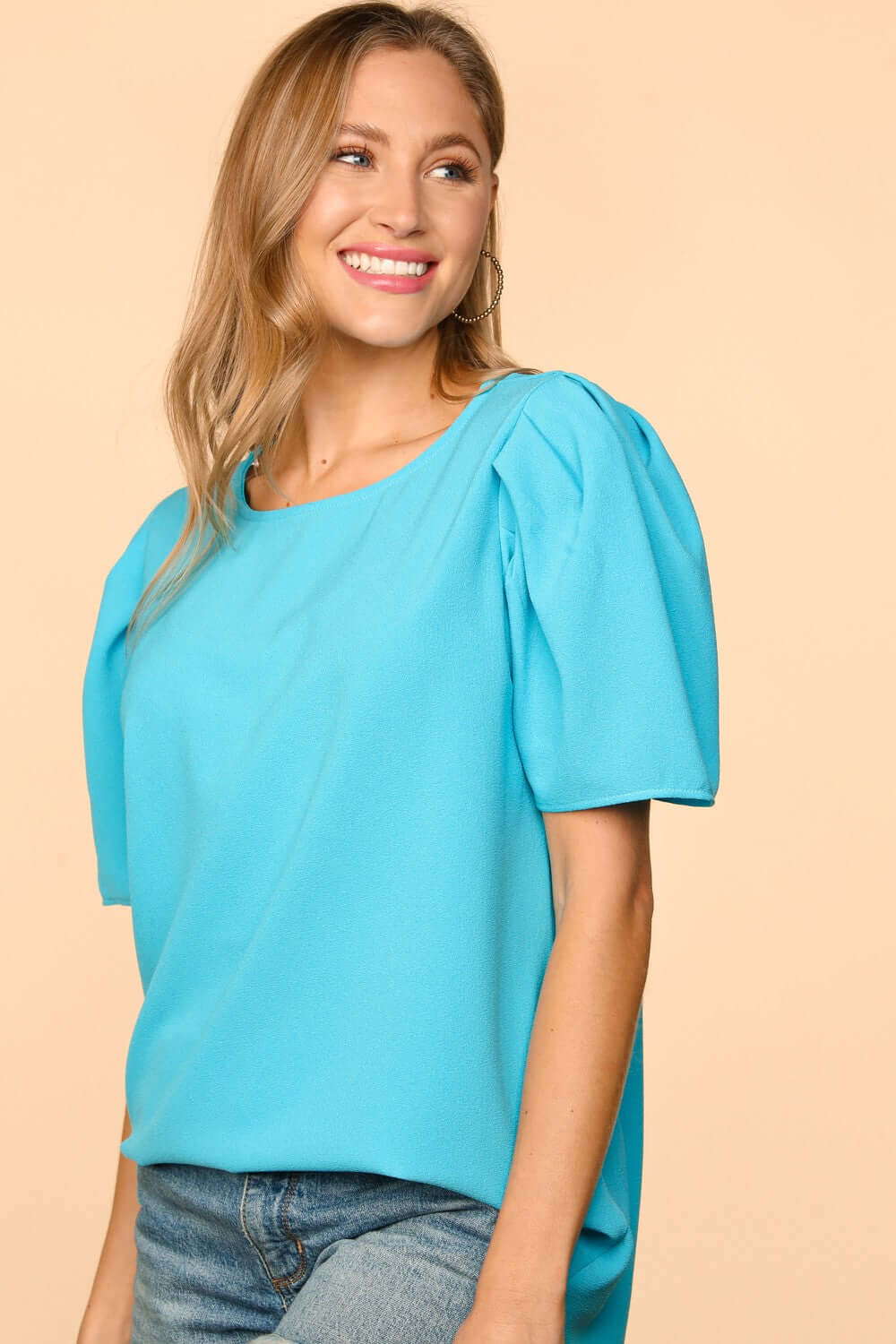 Model wearing the Blue Haven Top by Haptics in aqua with bubble puff sleeves and a round neckline.