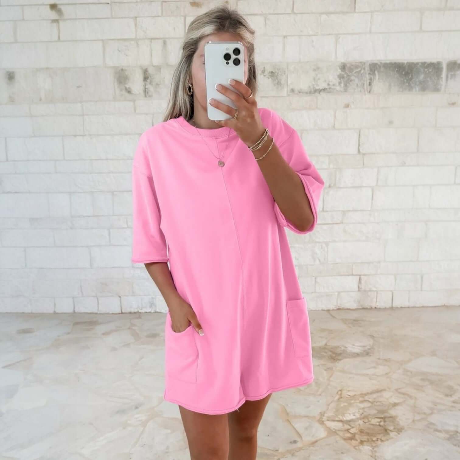 Model wearing a pink Casual Escape Romper with relaxed fit and pockets, showcasing modern casual style and comfort.
