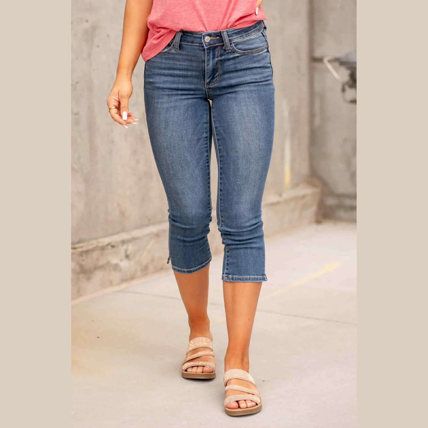 Model wearing Judy Blue Kenzie Mid Rise Capris in medium blue wash with sandals, perfect for warm weather.