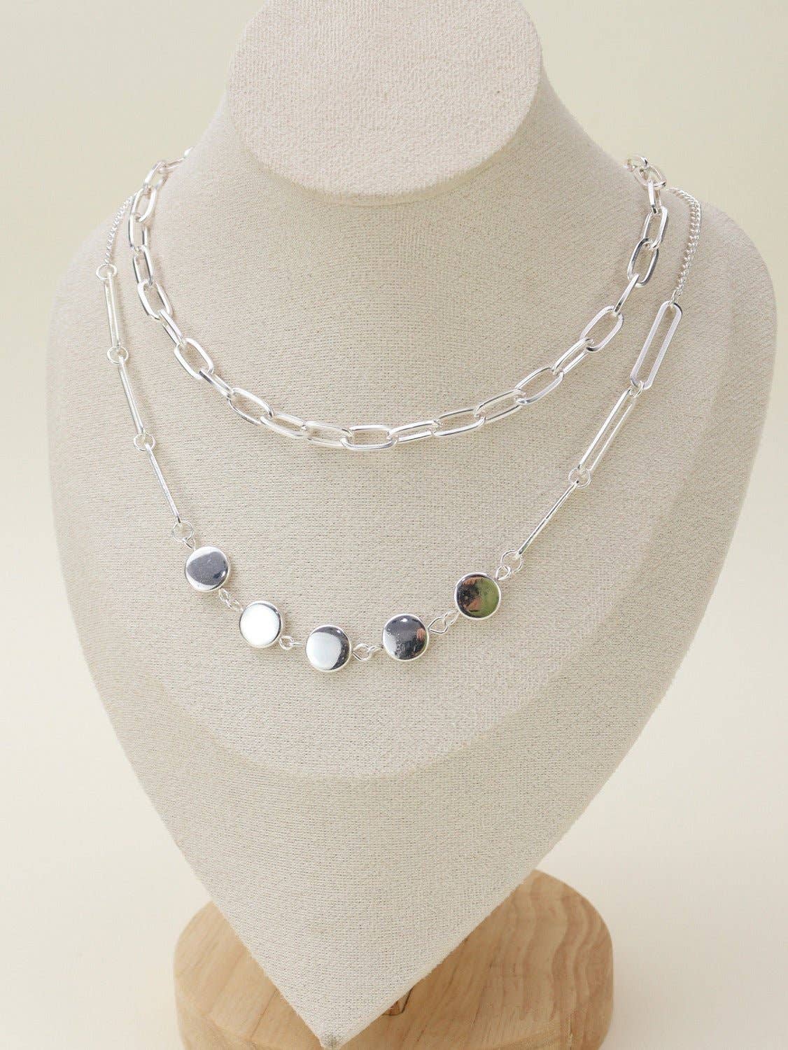 Two layer silver chain necklace set displayed on a jewelry bust, showcasing its elegant design and versatility.