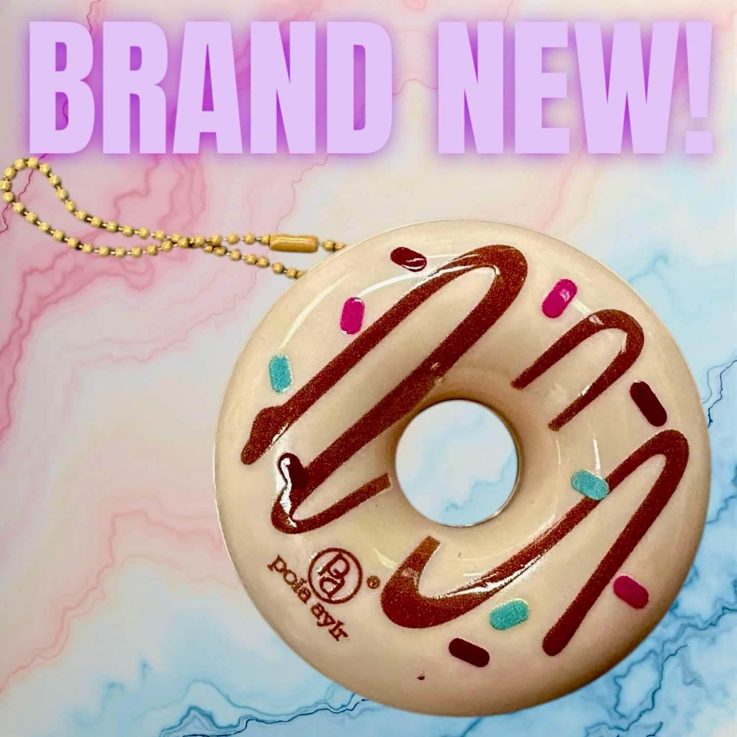 Donut Worry Lip Balm keychain in pastel colors, perfect for on-the-go lip care with a sweet donut design.