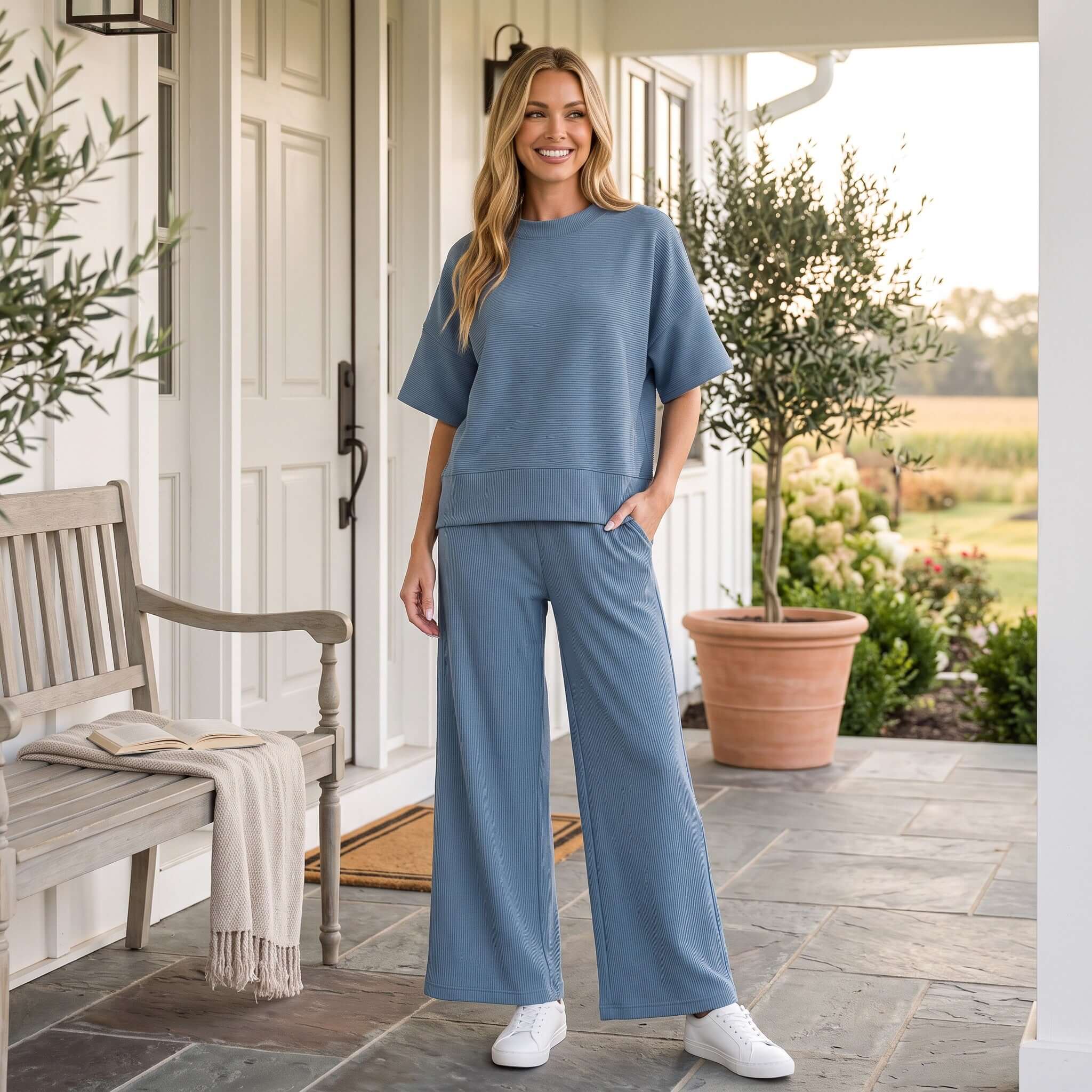 Fashionable woman wearing BLUE HAZE PANTS SET, featuring a relaxed top and wide-leg pants in soft blue.