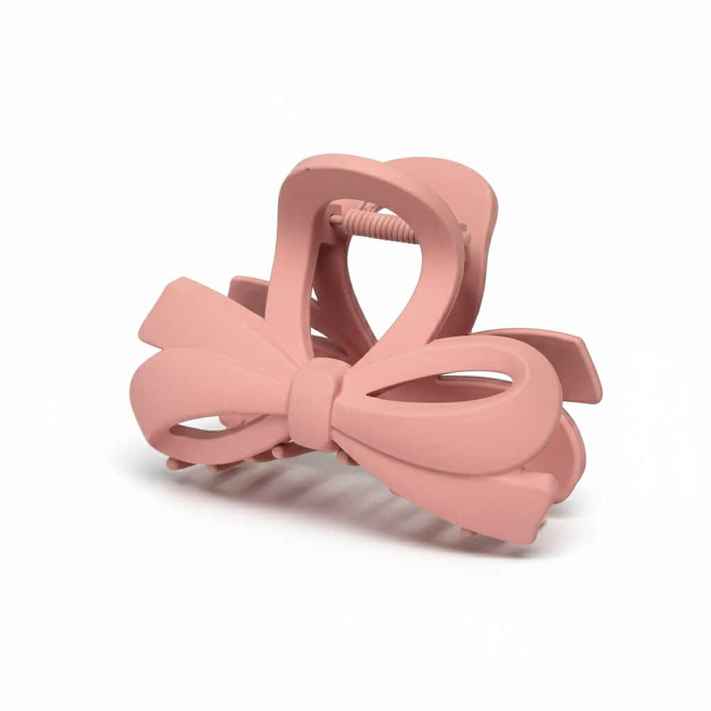 DAILY DARLING BOW HAIR CLIP (6 colors) in soft pink, showcasing a charming bow design.