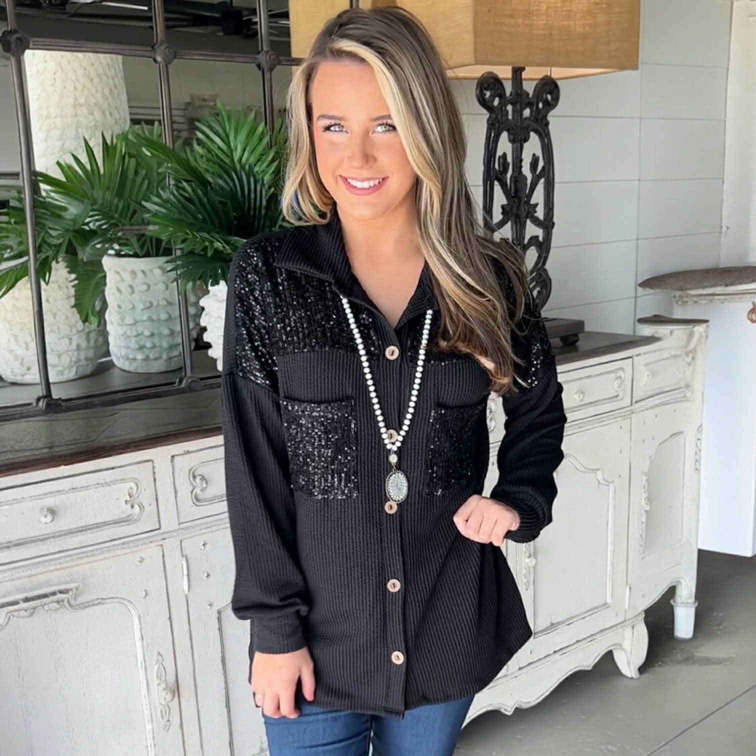 CITY LIGHTS TOP – Black sequin patch corded shacket styled with jeans and a statement necklace.