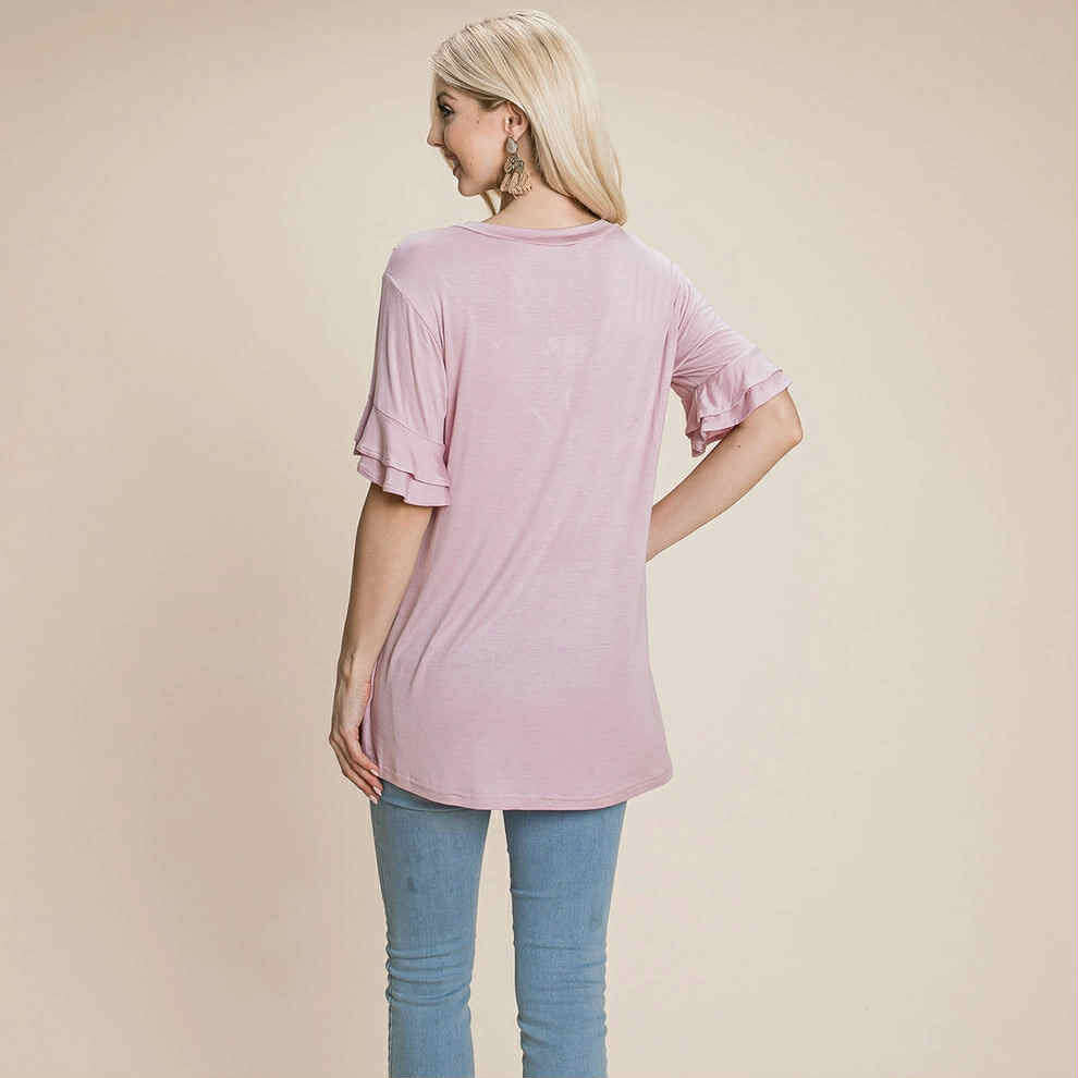 Back view of a woman wearing the Delicate Directions Top in soft pink with ruffled sleeves and relaxed fit.
