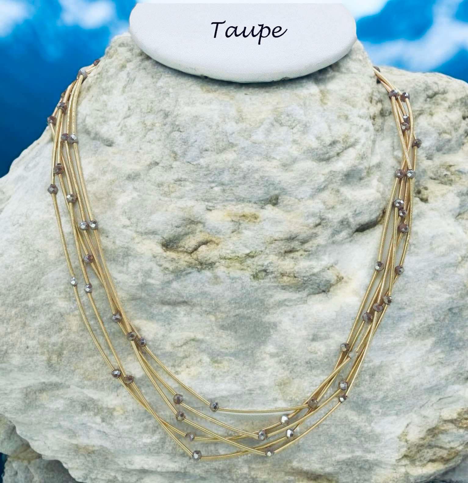 Pretty Strands Necklace in taupe, featuring glass beads on a gold tone multi strand design, 22 inches long.