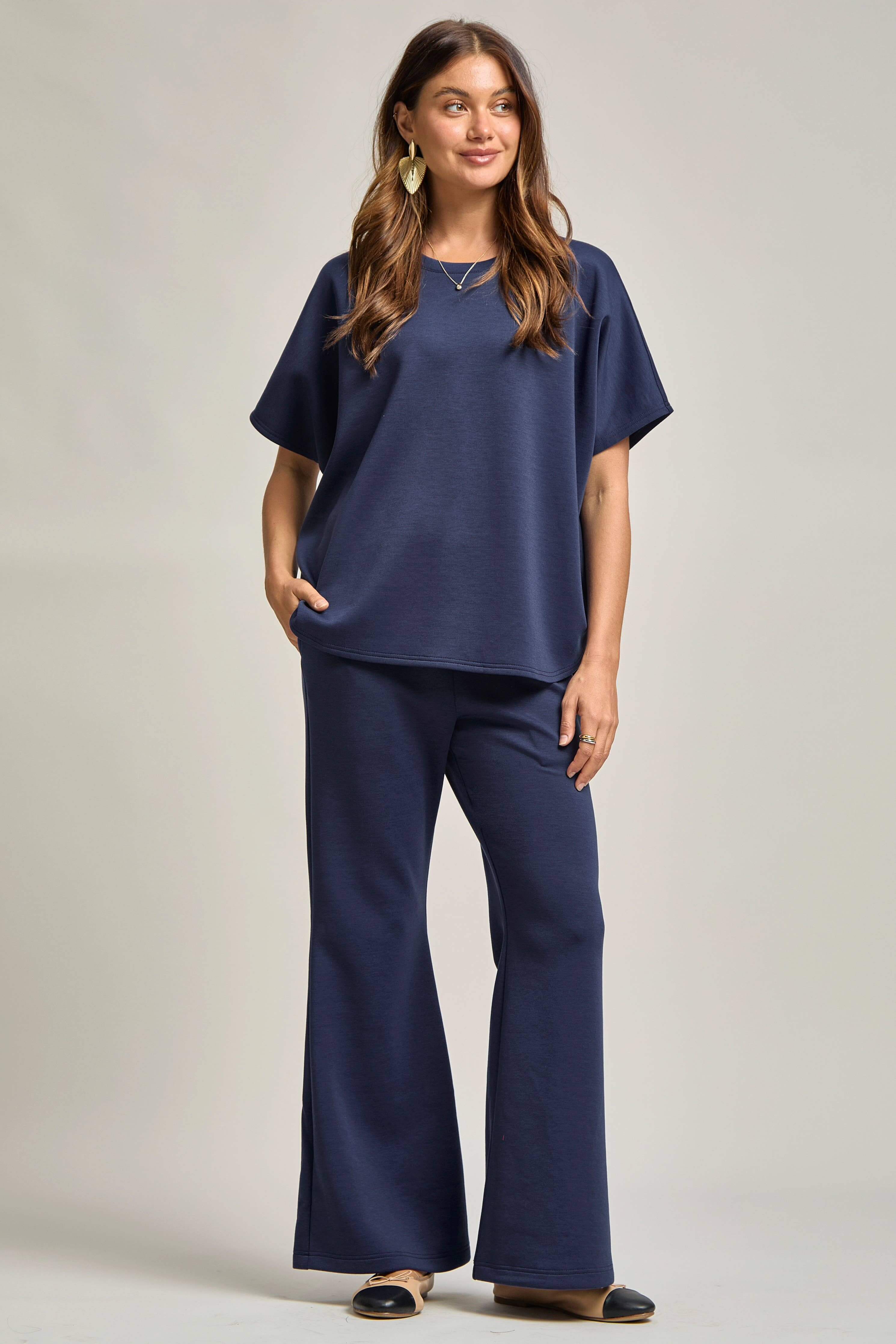 Poncho Top + Bell Bottom Modal Set shown on model, featuring a relaxed poncho top and bell-bottom pants in navy.