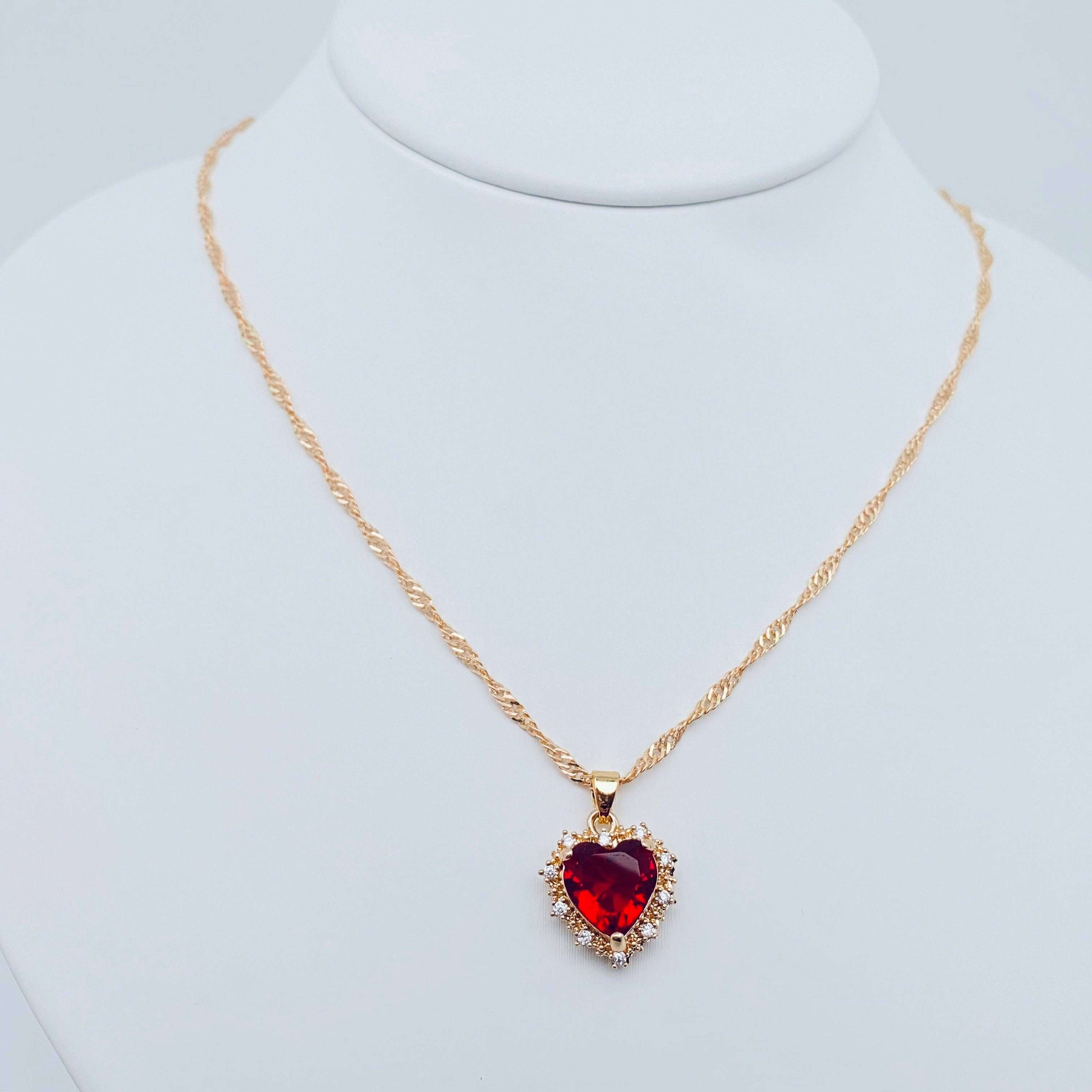 Heart-shaped Pendant Necklace Inlaid Cubic Zirconium showcasing a red heart-shaped pendant with a golden chain.