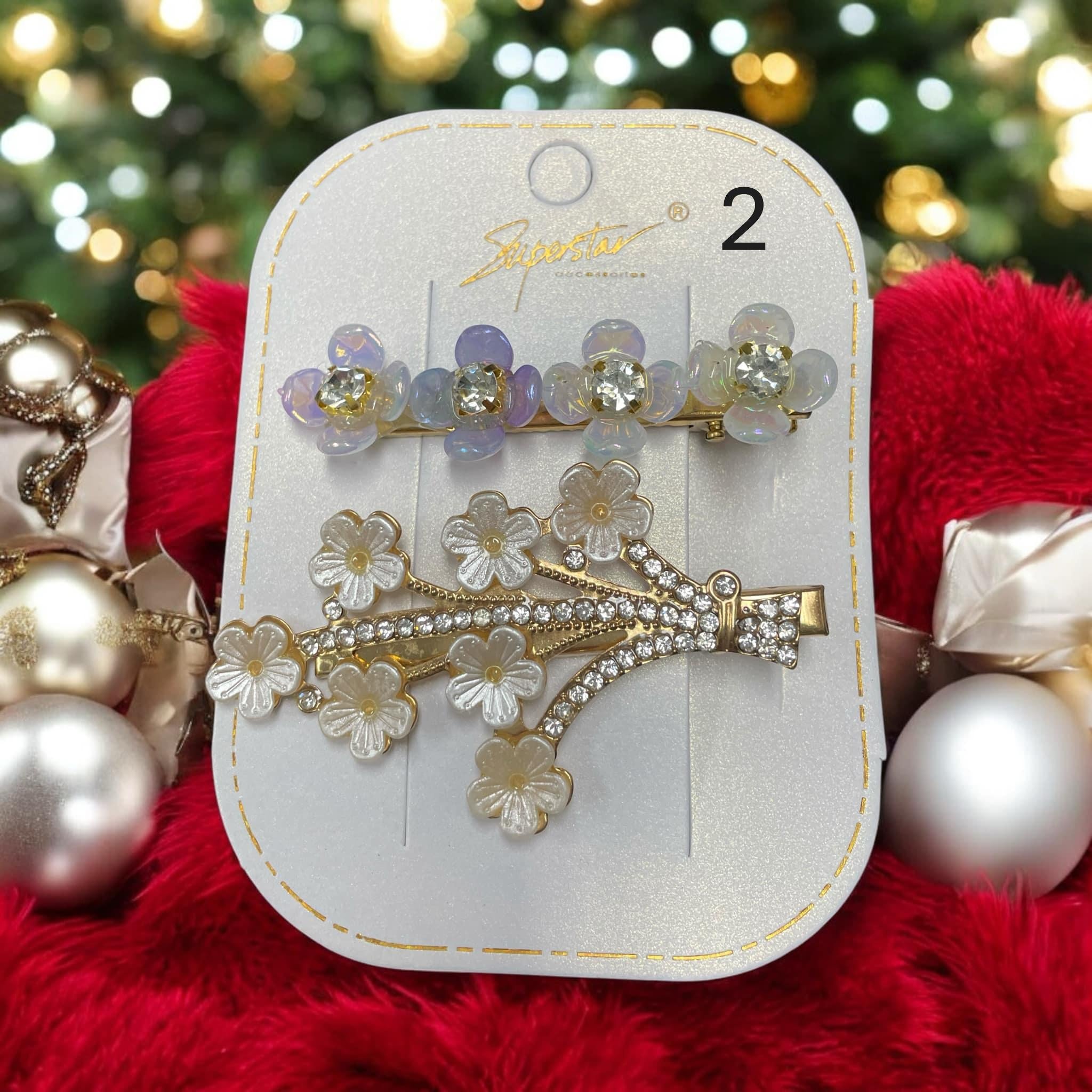 Set of two bejeweled hair clips with rhinestones and flower designs, perfect for holiday styling.