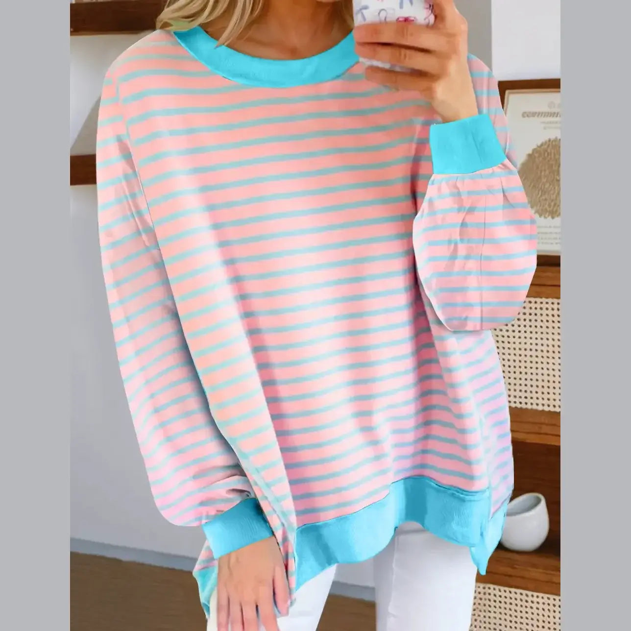 SALTWATER TAFFY TOP featuring soft pink and aqua stripes with a stylish high-low design and comfortable fit.
