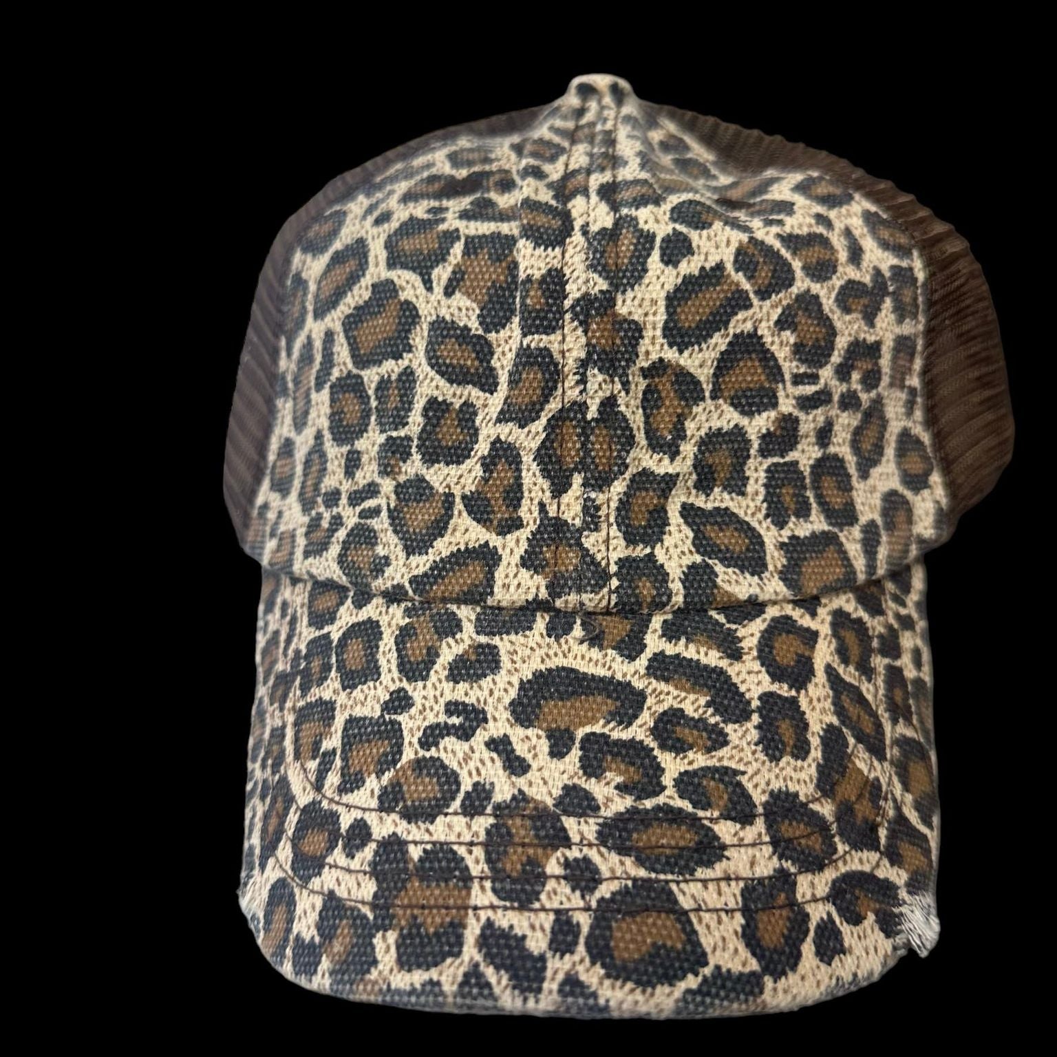 Stylish leopard print trucker hat with distressed twill design and mesh back, perfect for a chic look.