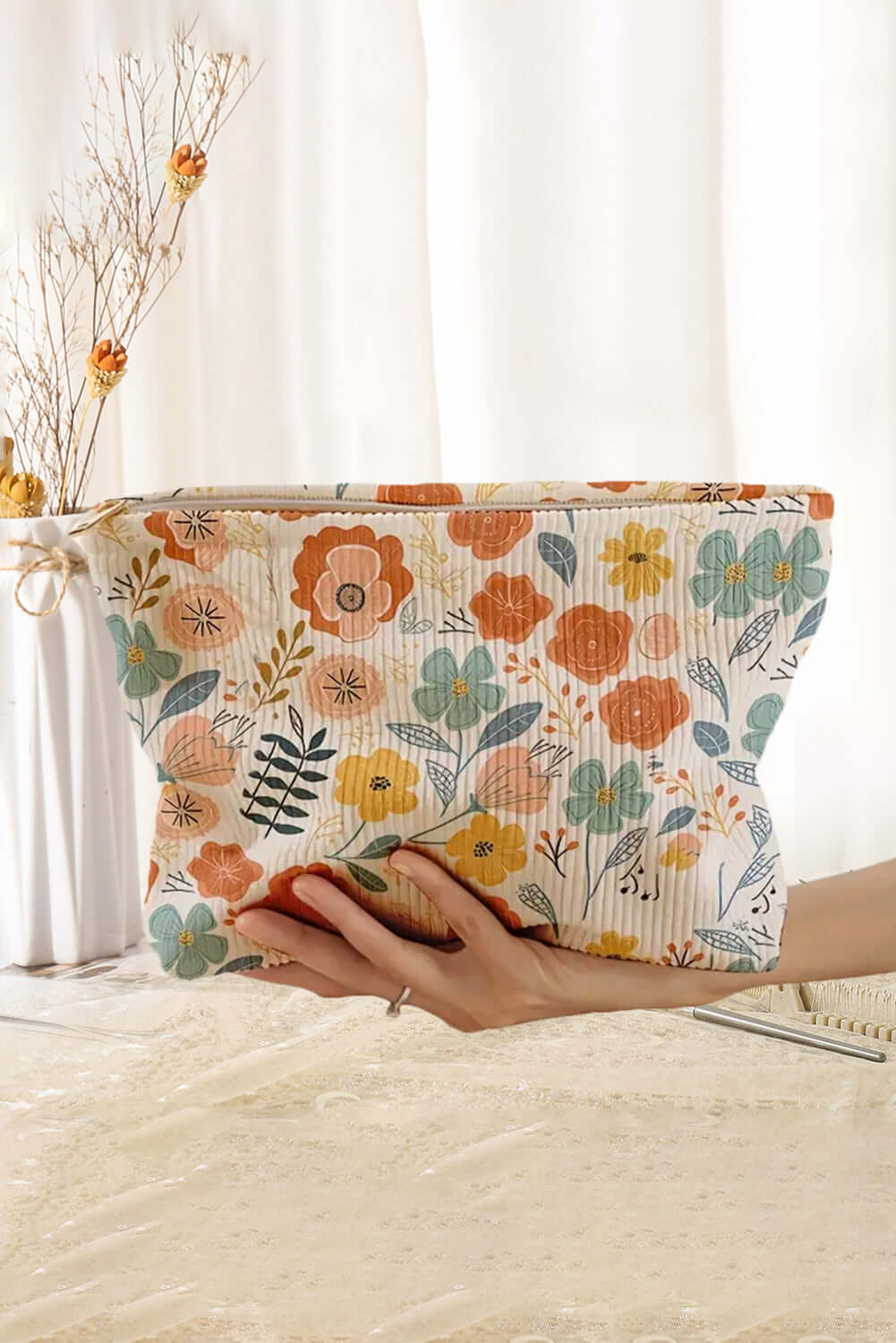 Ivory floral corduroy cosmetic bag featuring vibrant flower design, perfect for travel and everyday use.
