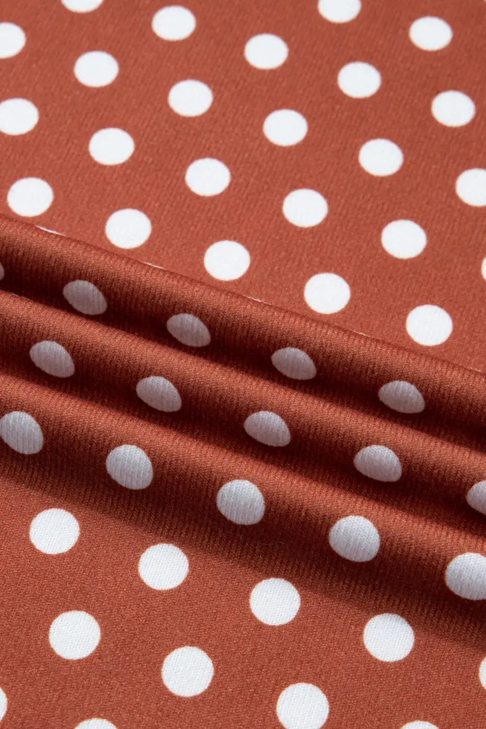 ON THE DOT SHORTS SET fabric featuring mocha color with classic white polka dots, showcasing its soft texture and playful design.