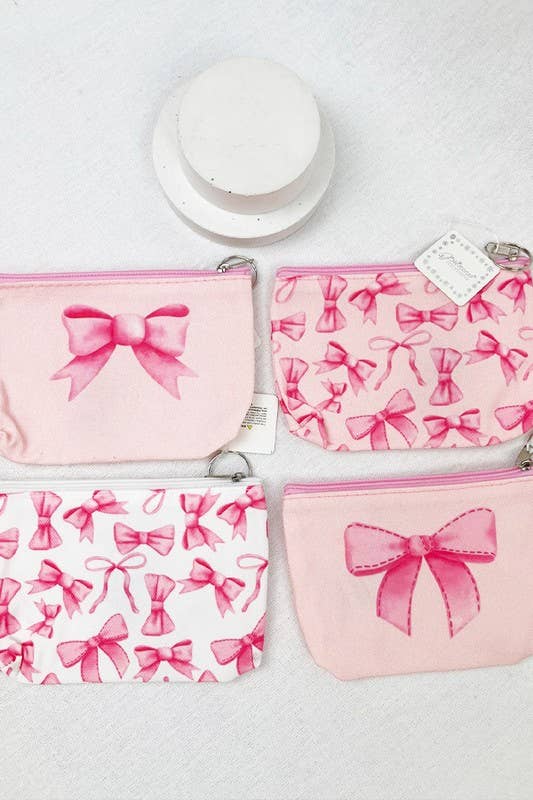 Four stylish pink cosmetics bags featuring cute bow designs, perfect for organizing makeup essentials on the go.