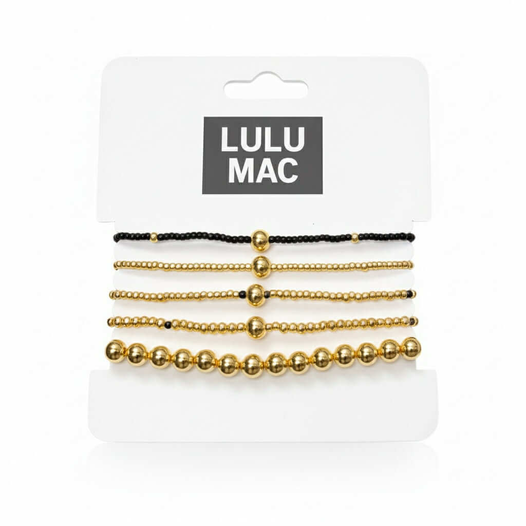 LULU MAC STACKED SERENITY 5 BRACELET SET featuring black and gold bracelets on a display card.