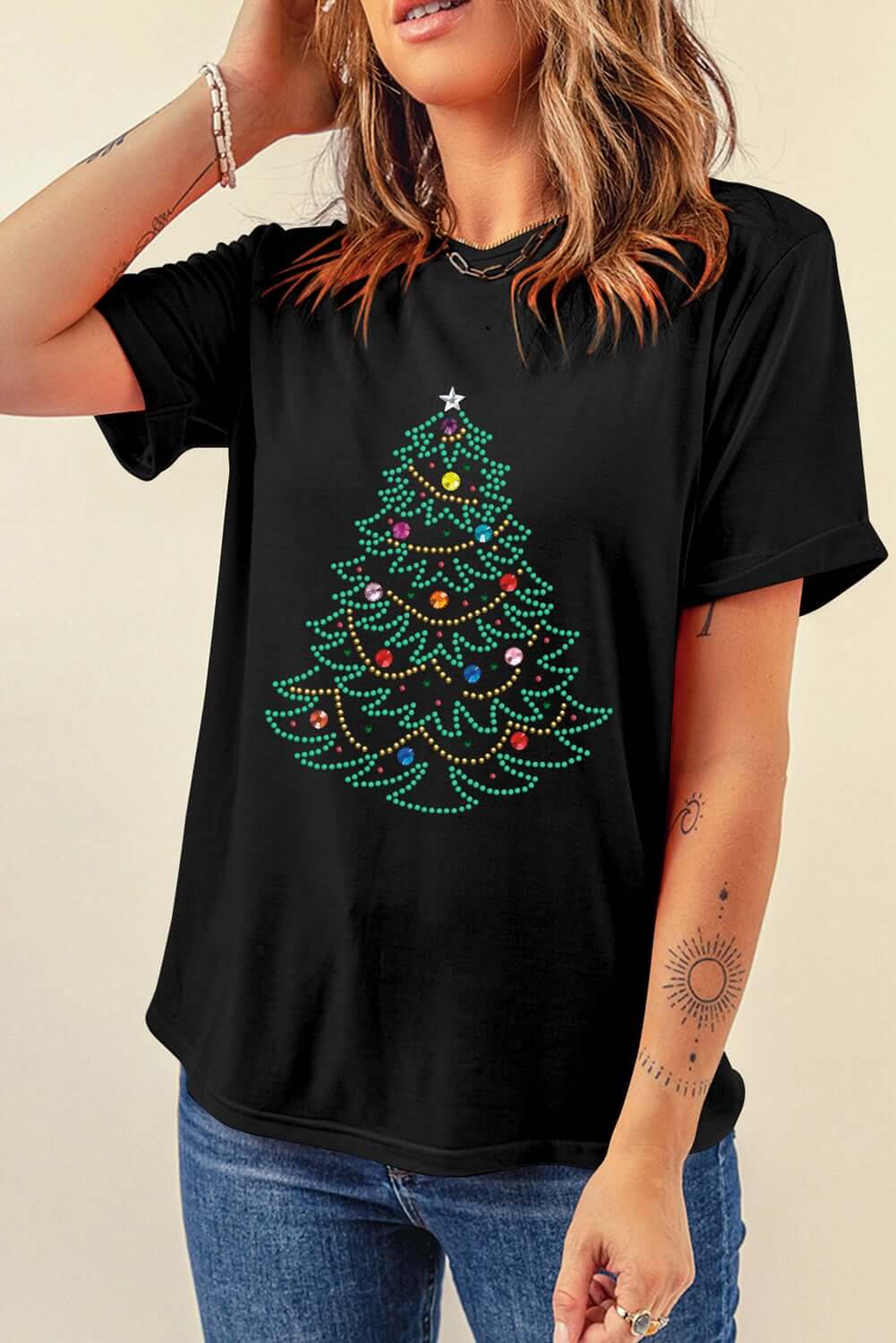 Black t-shirt featuring a fully studded Christmas tree design, perfect for festive casual wear.