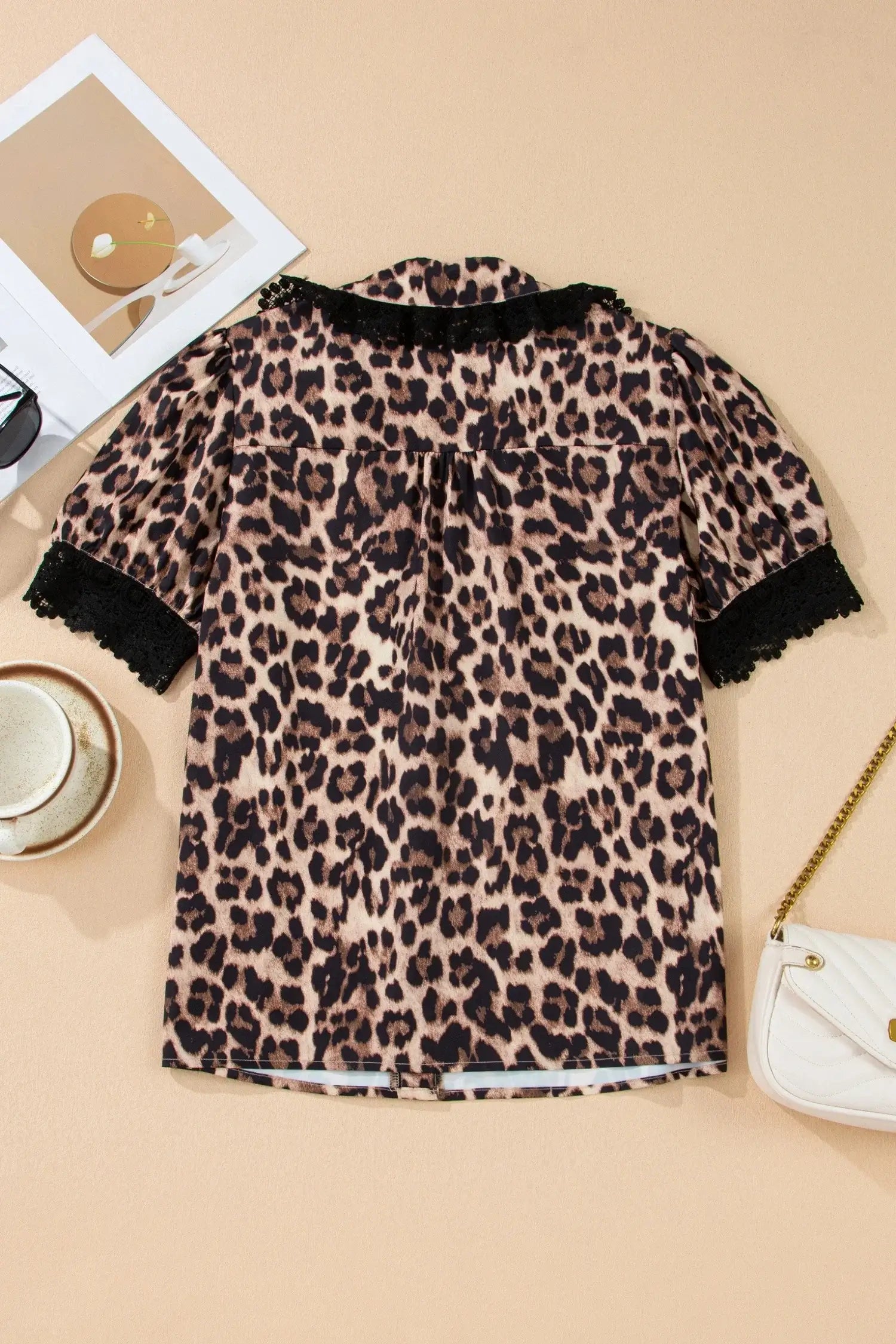LEOPARD AND LACE TOP featuring a trendy leopard print design with lace trim sleeves on a stylish background.