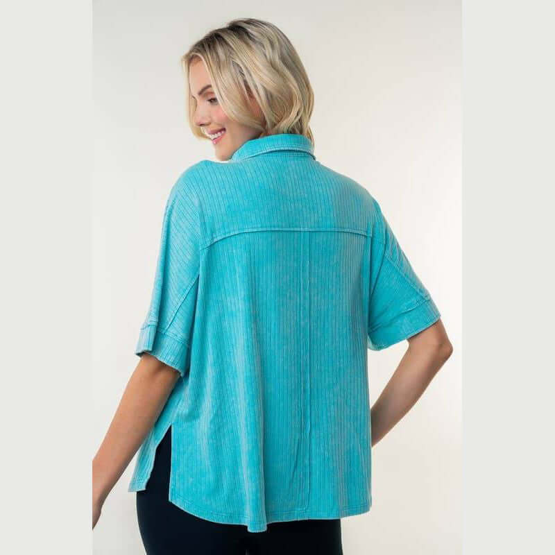 Back view of Downtown Breeze Top in aqua, featuring a collared design and relaxed fit with side slits.