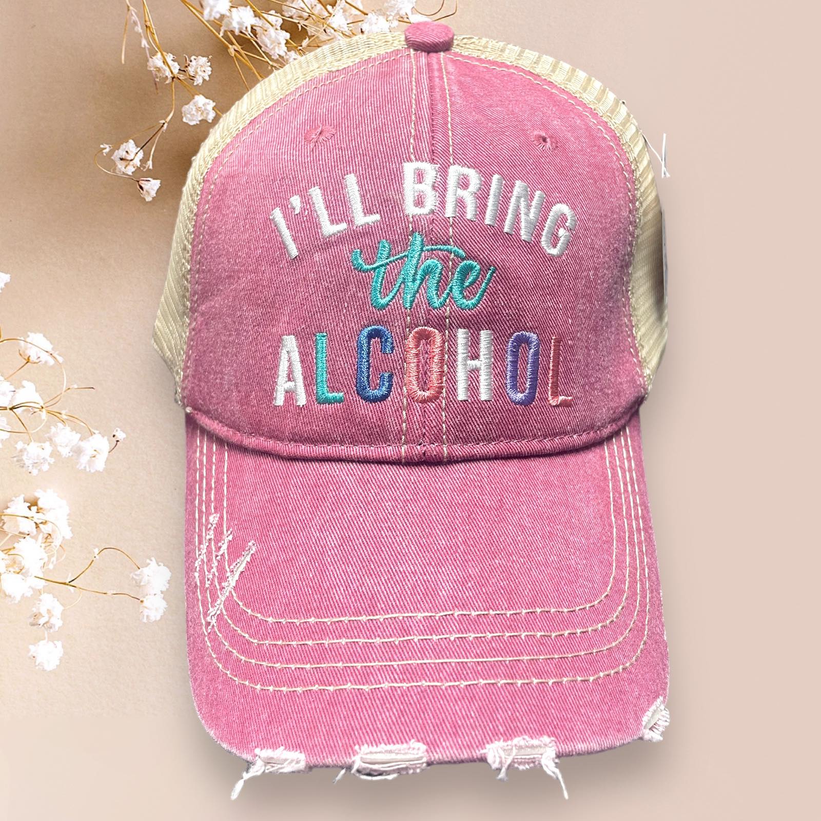 Distressed pink Katydid baseball cap with the phrase 'I'll Bring the Alcohol' and adjustable mesh back.