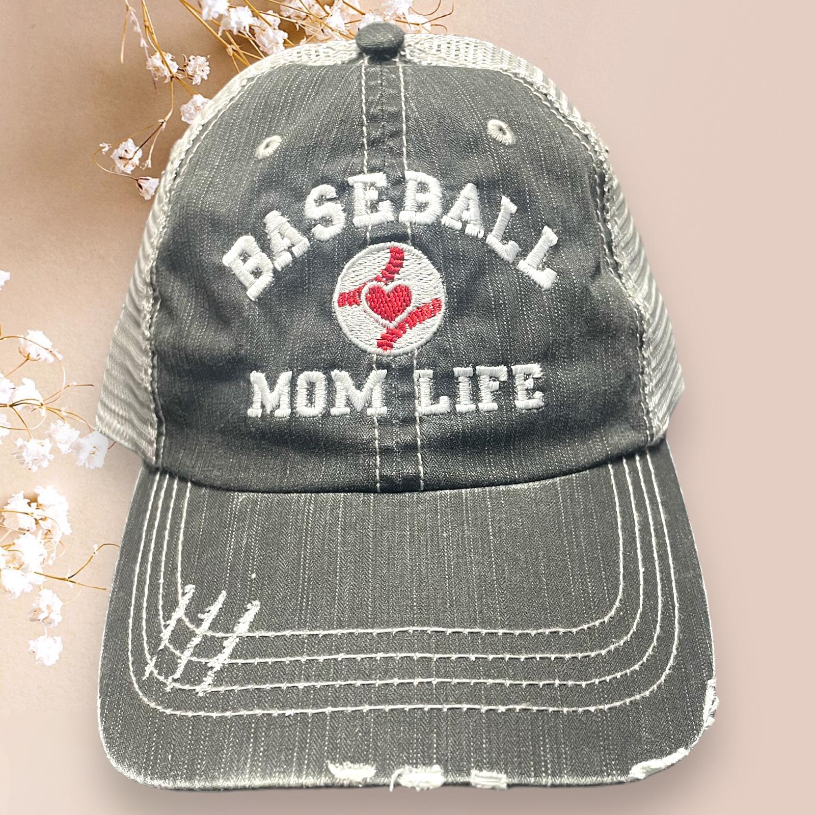 Distressed Katydid baseball cap with 'Baseball Mom Life' embroidery and adjustable mesh back.