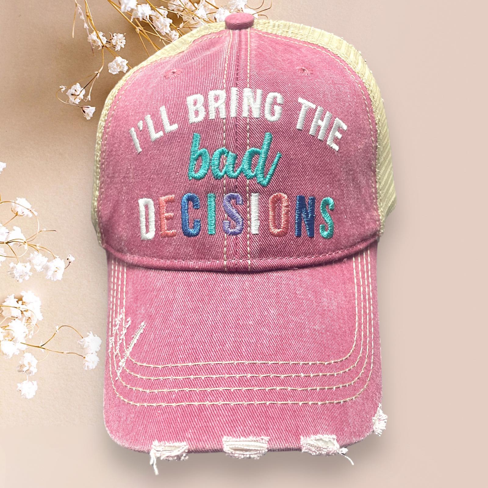 Distressed pink Katydid baseball cap with multicolor text saying 'I'll Bring The Bad Decisions', perfect for retro style.