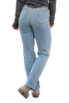 Woman in high-rise Judy Blue Raleigh jeans, showcasing the back view and straight fit with faded denim.