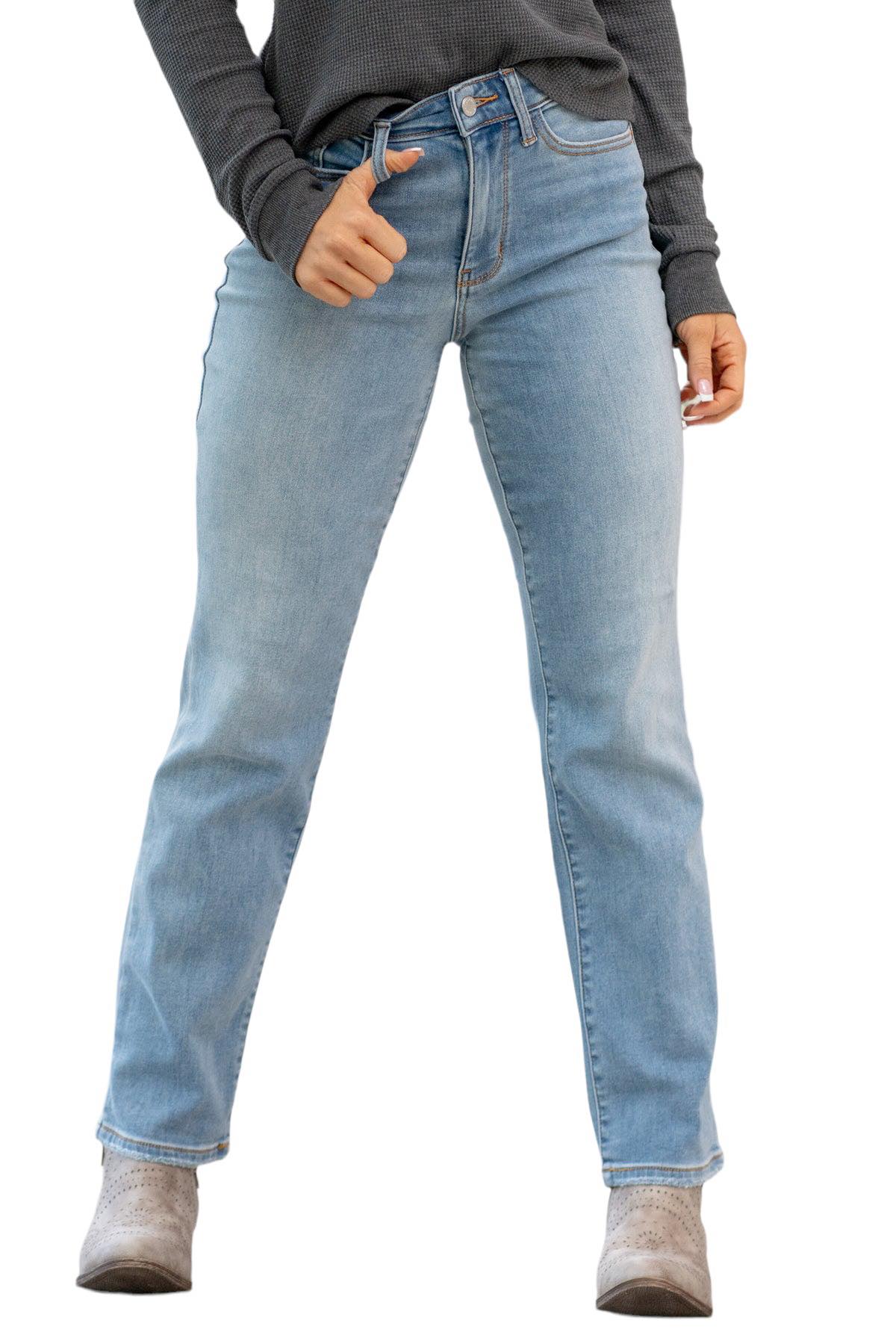 Woman wearing Judy Blue Raleigh Thermal Jeans, high-rise straight fit in faded denim with stylish gray top.