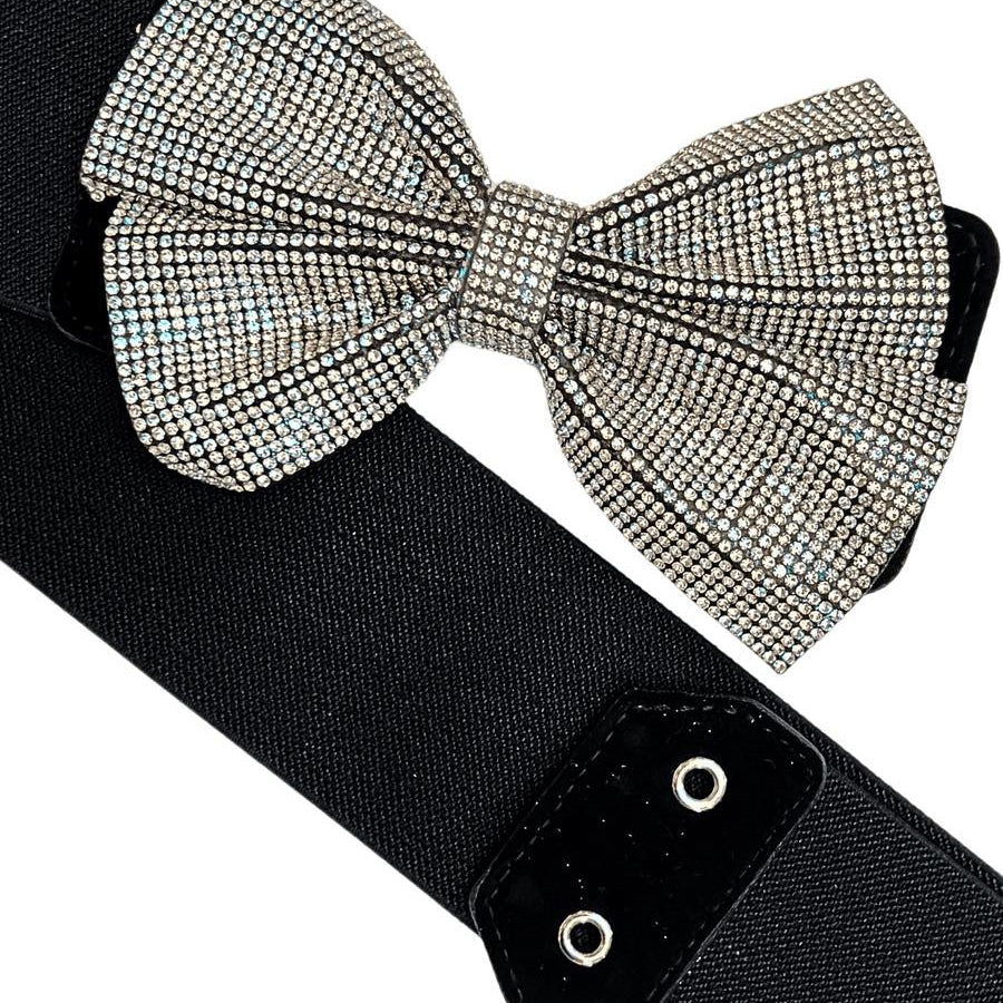 Sparkly rhinestone bow on a black elastic belt, perfect for adding style to any outfit.