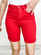 JUDY BLUE tummy control shorts in vibrant red, featuring a high-waisted design and rolled hems.
