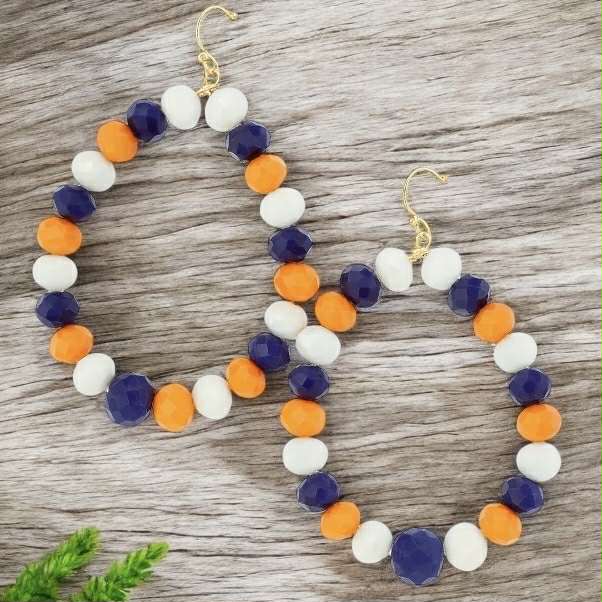 Colorful beaded teardrop earrings in blue, orange, and white with gold hooks, perfect for adding style to any outfit.