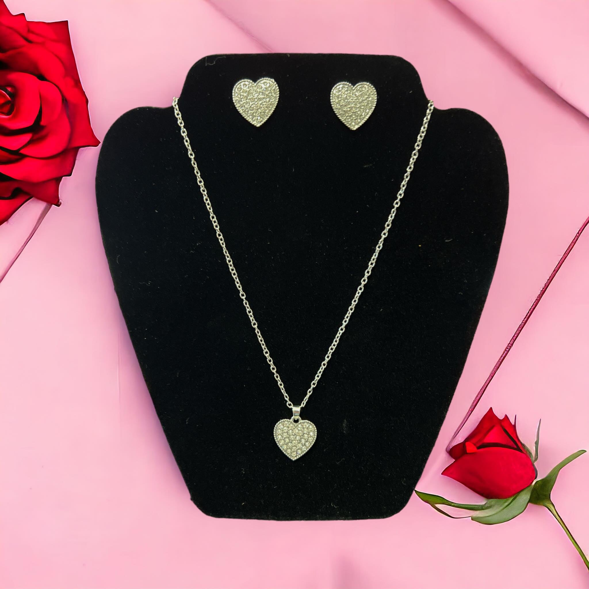 LOVE STORY earrings and necklace set with heart-shaped designs in silver tones, perfect for romantic occasions.