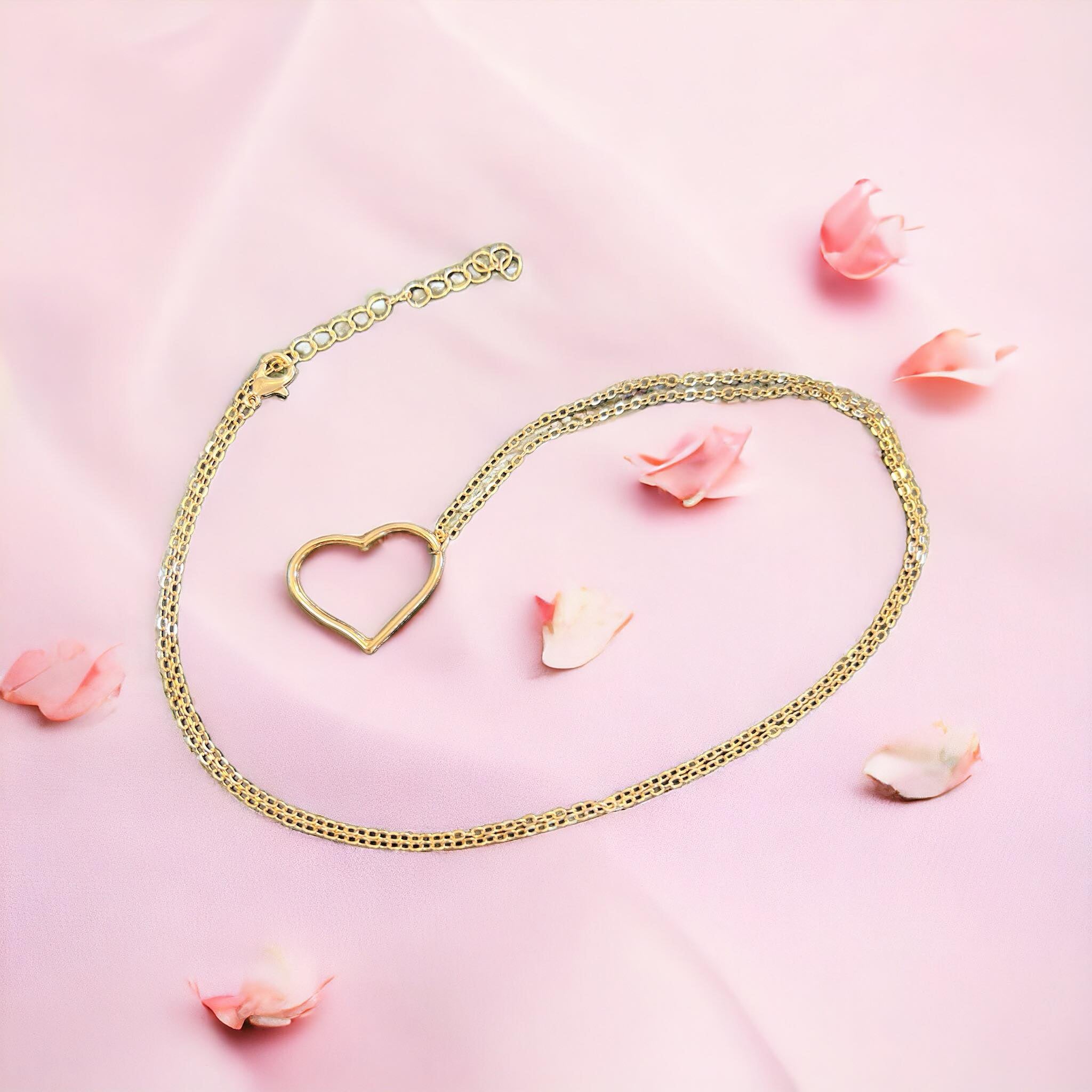 Open Heart Necklace on pink fabric with petals, available in gold tone, perfect for expressing love.