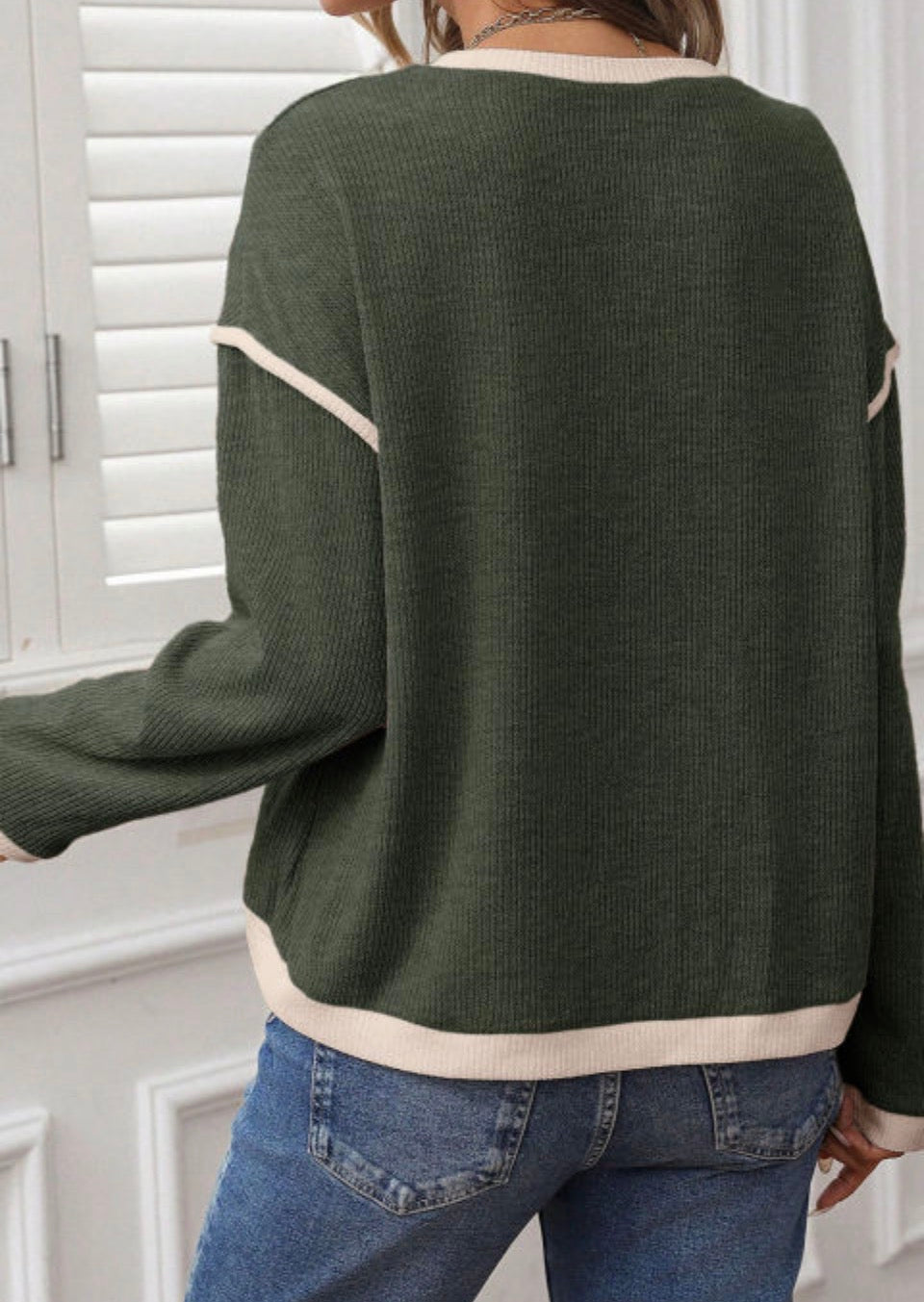 Back view of a green EARTHLINE ENERGY TOP showcasing its relaxed fit and stylish design.