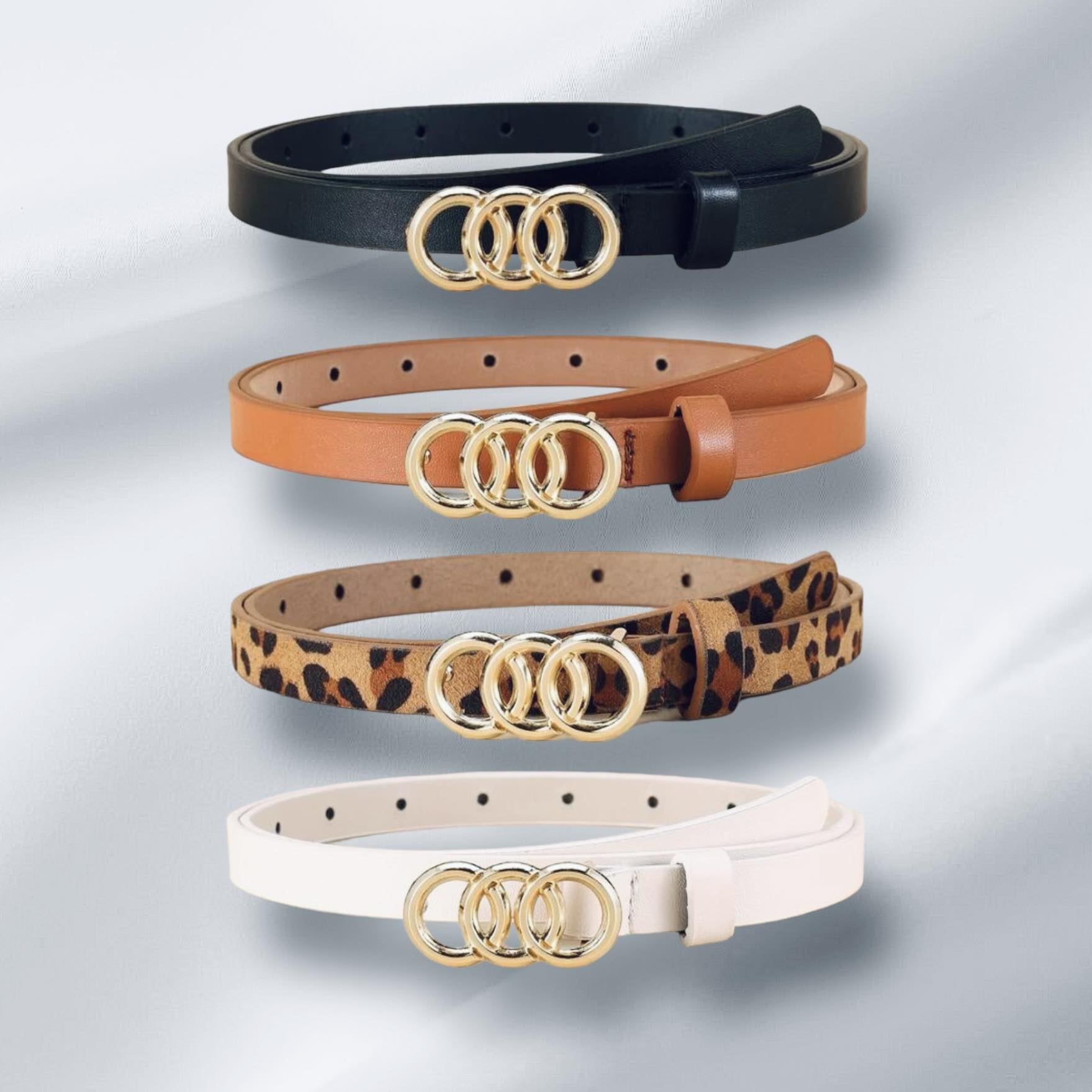 Circles of Life Belts in black, tan, leopard, and white with gold tone overlapping circles.