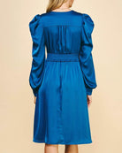 Back view of the Indigo Hour Midi Dress by Pinch, featuring smocked waist and elegant blue silky fabric.