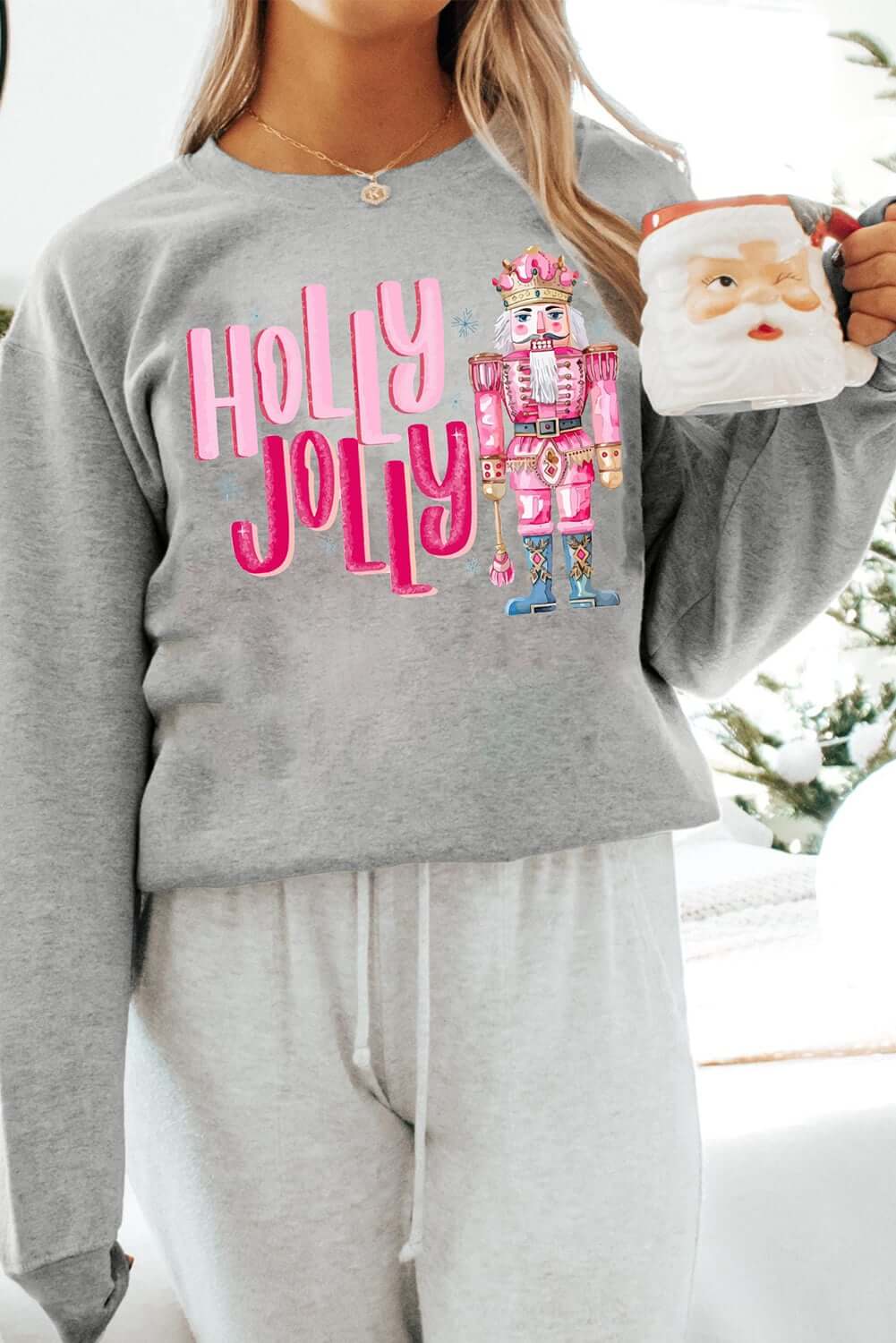 Gray Christmas sweatshirt featuring a nutcracker and 'HOLLY JOLLY' print, perfect for festive holiday style.