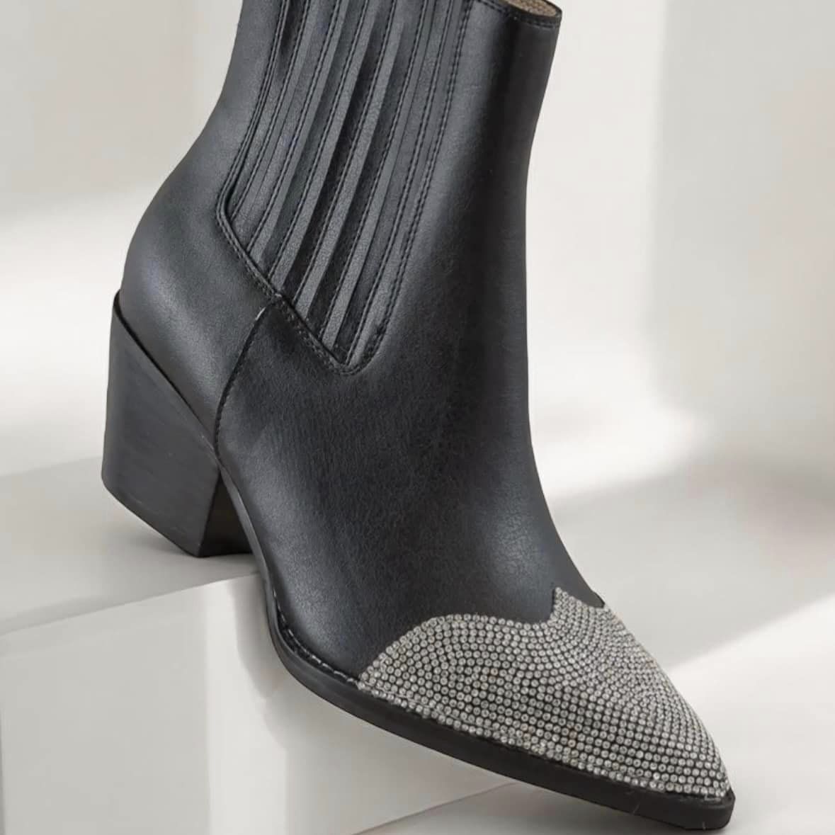 Rhinestone Cowgirl black booties featuring a dazzling rhinestone toe cap and sleek design for chic elegance.