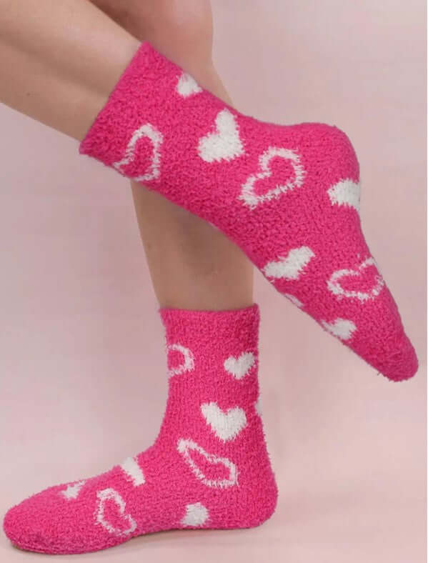 Cozy pink Heart's Delight socks with white heart patterns for warmth and style.