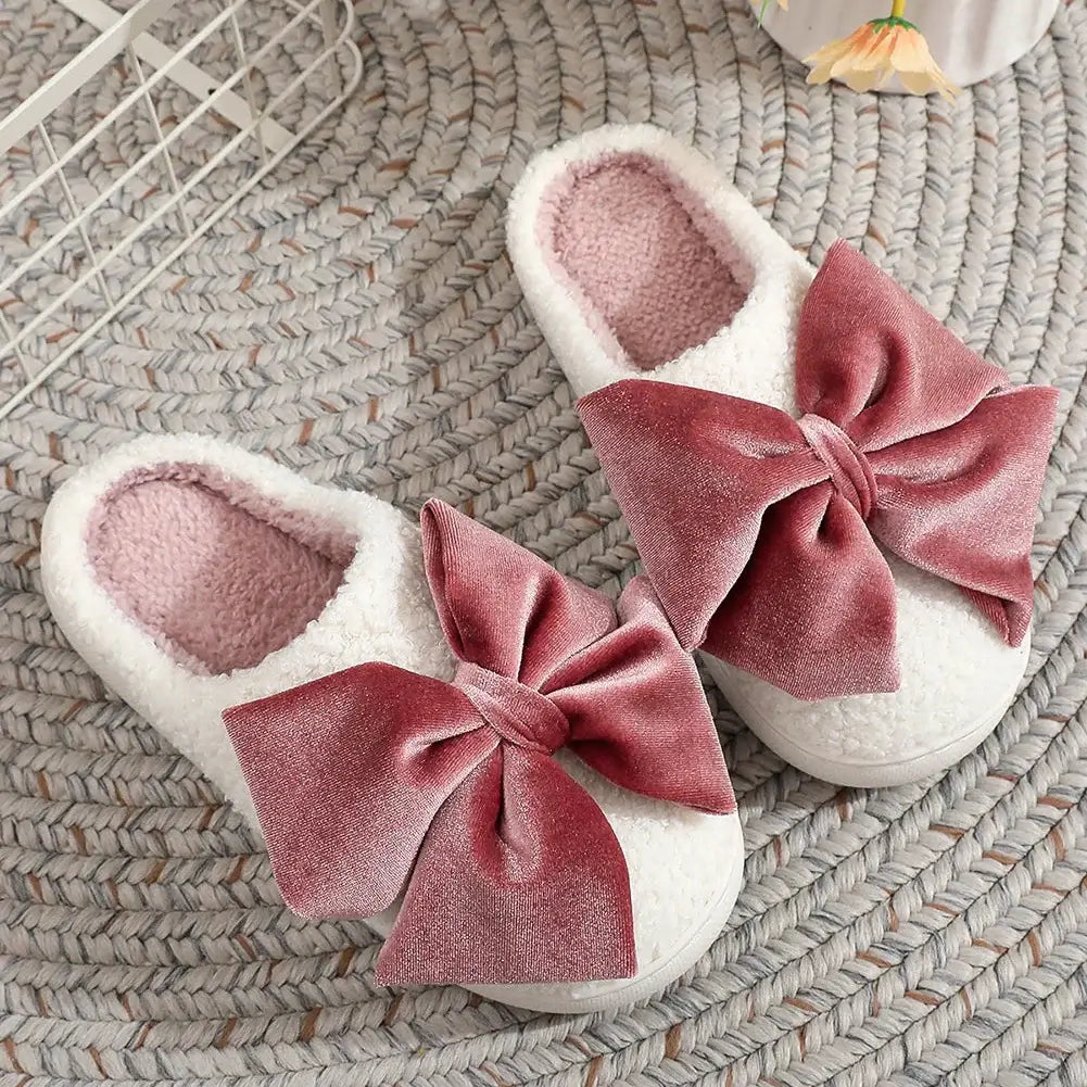 SWEET RETREAT BOW SLIPPERS featuring plush sherpa exterior and oversized velvet bow for cozy winter style.