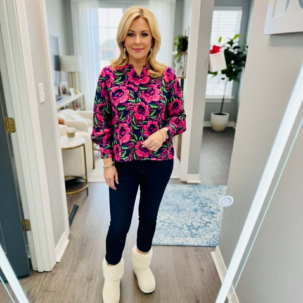 Model showcasing the SIENNA LOVESTRUCK TOP by Michelle McDowell with a vibrant floral print in a stylish setting.