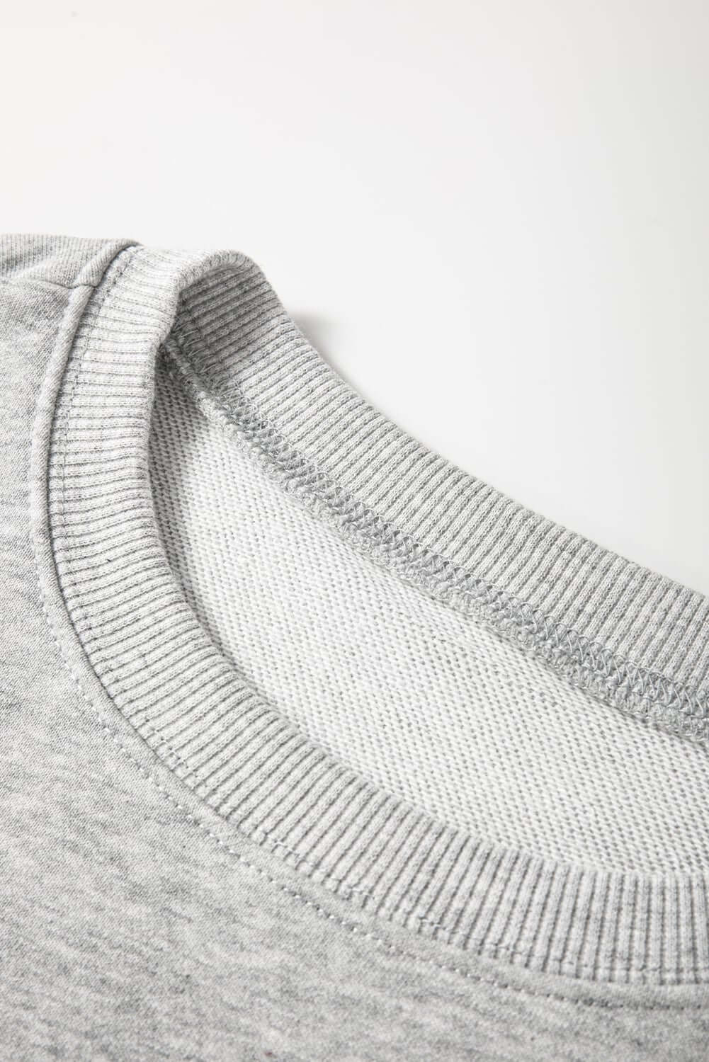 Close-up of gray sweatshirt collar showcasing soft fabric and ribbed neckline.
